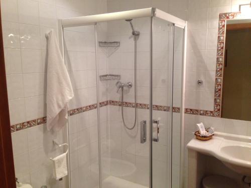 a shower with a glass door in a bathroom at Hotel Los Desmontes in Membrilla