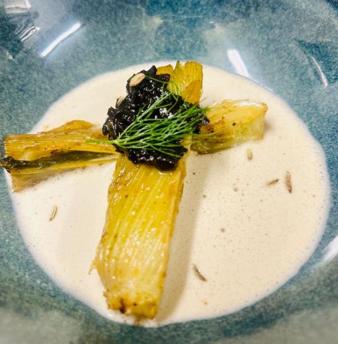 a plate of food with a piece of fish on it at Notre-Dame d'Escouloubre Sources d'eaux chaudes privées et sauna in Escouloubre