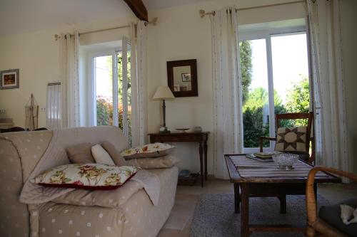un salon avec un canapé et une table dans l'établissement Gite le Maine des Rois, à Juillac-le-Coq