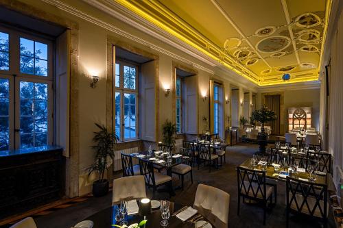 a restaurant with tables and chairs in a room at Pestana Palacio do Freixo, Pousada & National Monument - The Leading Hotels of the World in Porto