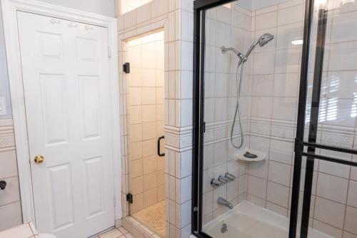 a bathroom with a shower with a glass door at Tranquil Poolside Oasis with BBQ and Serene Ambiance in North Hollywood