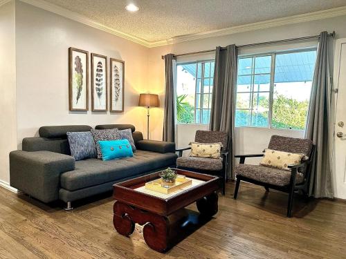 a living room with a couch and two chairs at Tranquil Poolside Oasis with BBQ and Serene Ambiance in North Hollywood