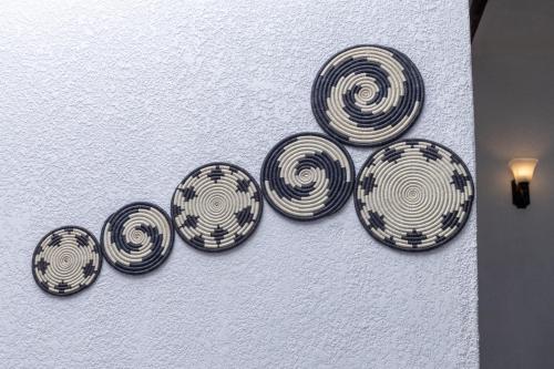 a group of plates hanging on a wall at Kabalega Resort - Hoima in Hoima