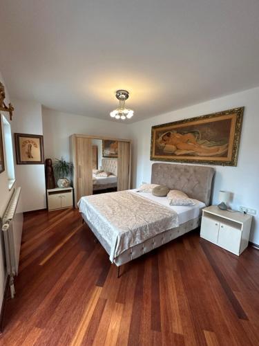 a bedroom with a bed and wooden floors at Apartment Starčević in Kampor