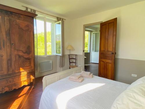 a bedroom with a bed with two towels on it at Chez Sylvain in Issor