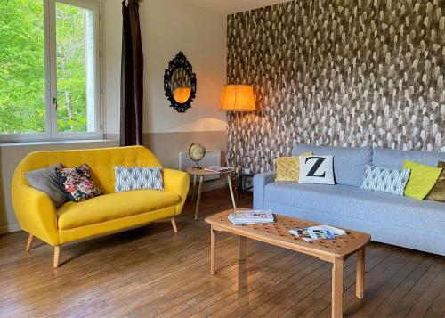 a living room with a couch and a table at Chez Sylvain in Issor