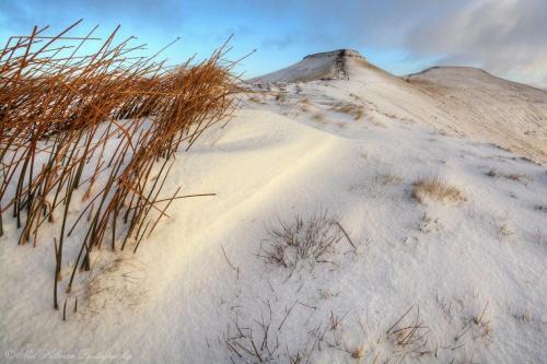 a sand dune with grass on top of it at James’ Place @ Bike Park Wales and The Brecon Beacons in Merthyr Tydfil