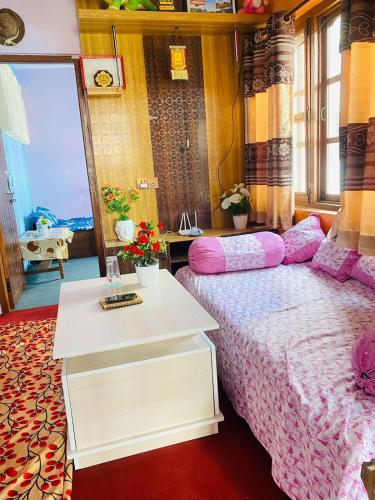a bedroom with a bed and a table and a mirror at Biva's Home, Kathmandu in Thimi