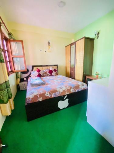 a bedroom with a bed with an apple comforter at Biva's Home, Kathmandu in Thimi
