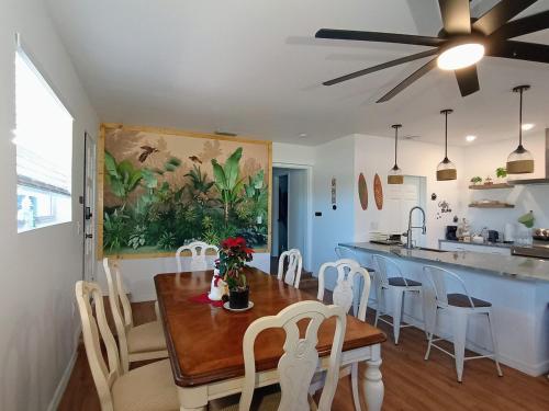 a kitchen and dining room with a table and chairs at St Pete heated pool hot tub 5 min to the beach in St Petersburg