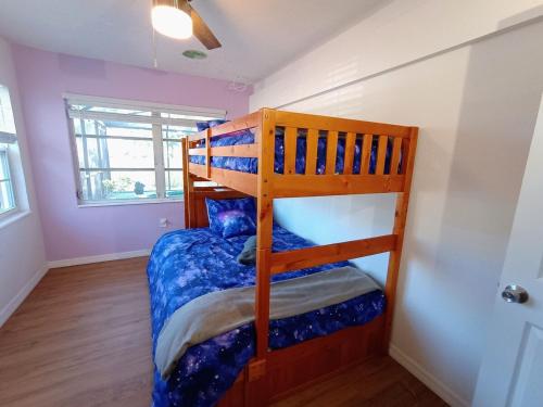a bedroom with a bunk bed in a room at St Pete heated pool hot tub 5 min to the beach in St Petersburg