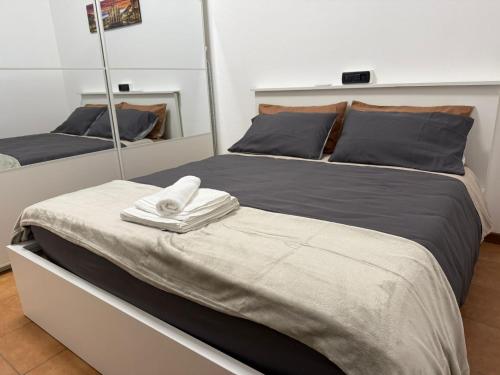 a bedroom with two beds and a mirror at Iris House - Rho Fiera in Rho