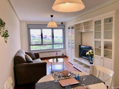 a living room with a couch and a table at Apartamento Europa Jardin in Oviedo
