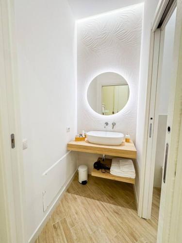 a bathroom with a sink and a mirror at Giandra Rooms and Garden in Messina