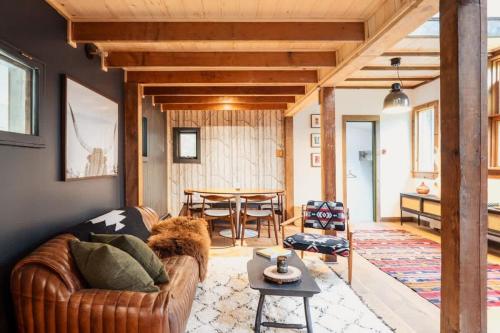 a living room with a couch and a table at Chic Catskills Cabin with Hot Tub and Fire Pit in Lanesville