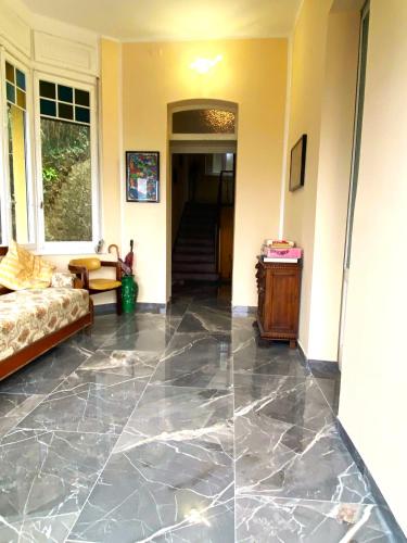 a living room with a large marble floor at Villa Silvana in Perledo
