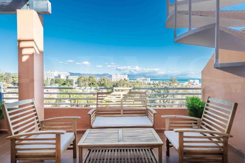 a balcony with chairs and a table and a view at Premium villa with private pool & garden by REMS in Torremolinos