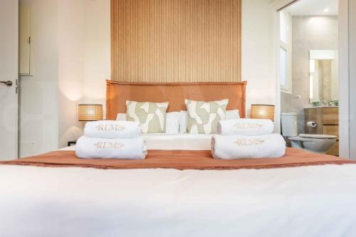 a bedroom with a large bed with white pillows at Premium villa with private pool & garden by REMS in Torremolinos