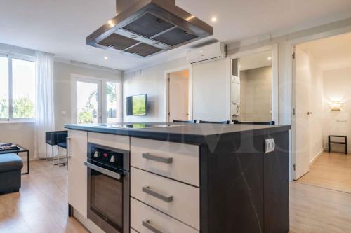 a kitchen with a black counter top in a room at Premium villa with private pool & garden by REMS in Torremolinos