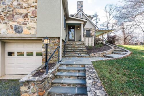 a house with a stone path leading to a garage at Relaxing Aldie Retreat with Fireplaces and Pool in Aldie