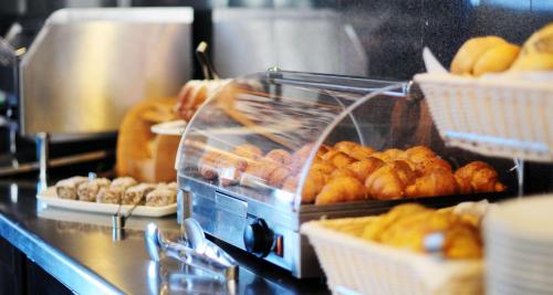 a bunch of donuts in baskets on a counter at Best Western Airport Hotel Stella in Zagreb