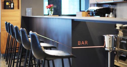 a bar with black stools in a restaurant at Best Western Airport Hotel Stella in Zagreb