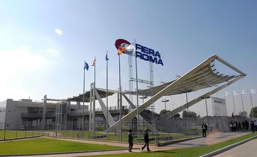 a group of people walking in front of a baseball stadium at Luciana Apt - 3 min train to FCO Airport & Fiera in Fiumicino