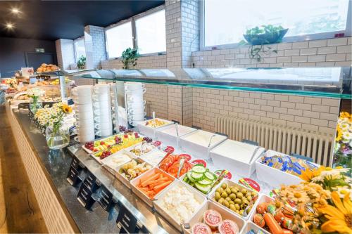 a produce section of a grocery store with fruits and vegetables at Best Western Hotel Kaiserslautern in Kaiserslautern