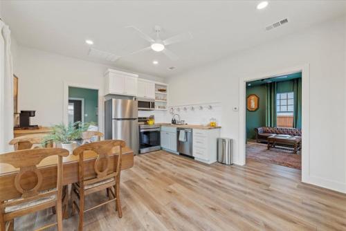 a kitchen and living room with a table and chairs at Gloria Cottage - 2 blocks to Magnolia and 3 mins to Baylor in Waco