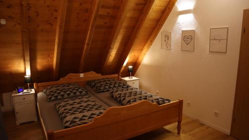 a bedroom with two beds in a room with wooden ceilings at Toskana in Klingenmünster