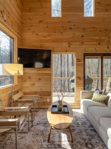 a living room with a couch and a table at Private Cabin with Guesthouse Hot Tub Fire Pits in Roscoe