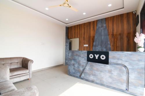 a lobby with a table with a sign that says oxy at Hotel O AB Residency in Āsansol