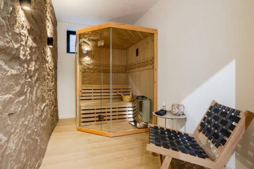 a room with a glass cabinet and a bench at Bright Suite I Sauna I TV I Kitchen in Gerolstein