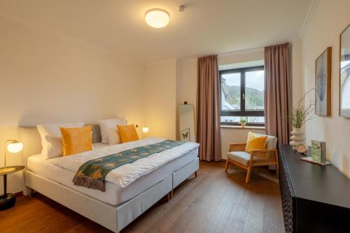 a bedroom with a bed and a desk and a window at Tropical Wellness Suite I Sauna I Whirlpool I Hot Tub I TV I BBQ in Büdesheim