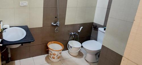 a bathroom with two toilets and a sink at Meadows Serene Retreat in Kannur
