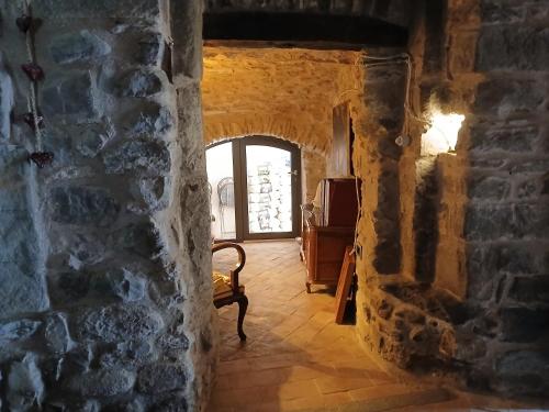 a hallway in a castle with a stone wall at Eremo Gioioso in Pontremoli
