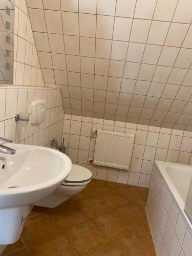 a bathroom with a white toilet and a sink at Pension zum Zenshaus kleine Auszeit in Lychen