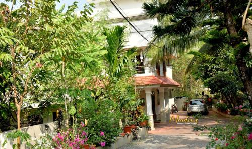a house with a lot of trees and plants at Meadows Serene Retreat in Kannur