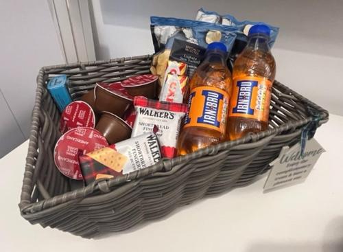 a basket filled with food and drinks on a table at Glenbervie - Beautifully refurbished, self-contained apartment in Fife