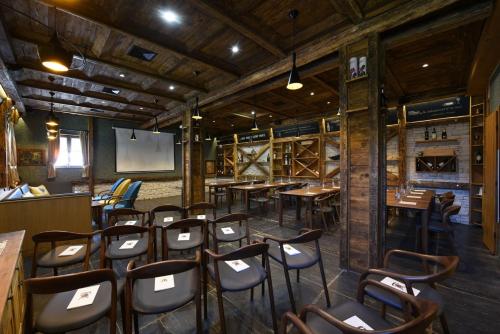 a room with tables and chairs in a restaurant at Lakeside Hotel Plitvice in Plitvička Jezera