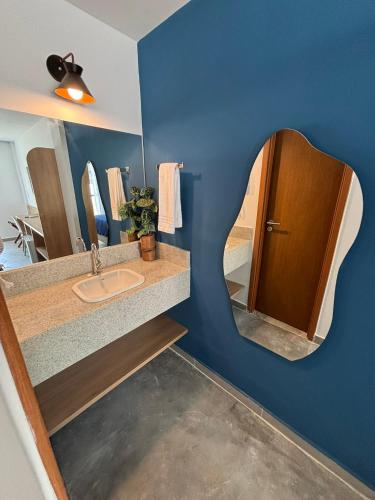 a bathroom with a sink and a mirror at Coralli Pousada in Porto De Galinhas