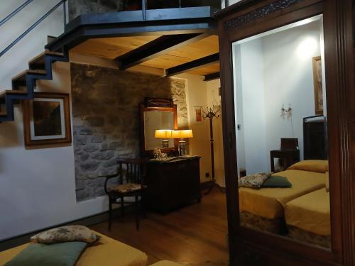 a bedroom with two beds and a mirror at Eremo Gioioso in Pontremoli
