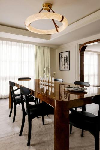 a dining room with a large wooden table and chairs at St. Regis Aspen Resort in Aspen