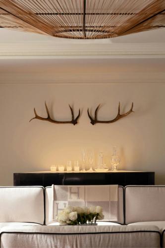 a living room with a couch and antlers on the wall at St. Regis Aspen Resort in Aspen