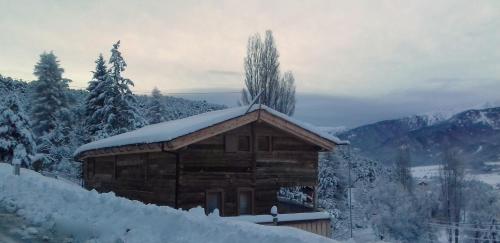 a wooden cabin covered in snow on a mountain at Ker Capcir in Bolquere Pyrenees 2000