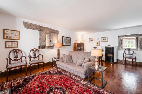 a living room with a couch and two chairs at Casa do Lagar in Cabeceiras de Basto