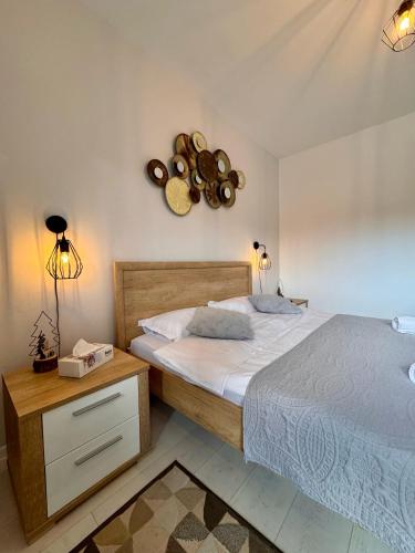 a bedroom with a bed and a clock on the wall at Apartament Alma in Sinaia