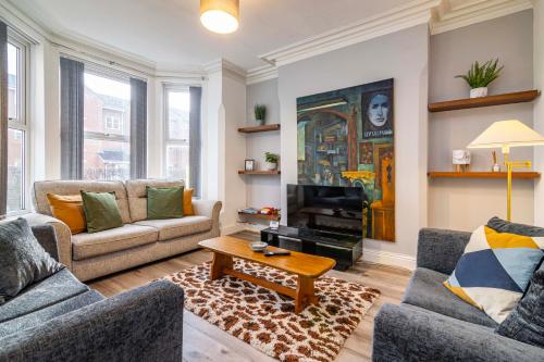 a living room with two couches and a coffee table at Motorpoint Arena House - Sleeps 10 in Nottingham