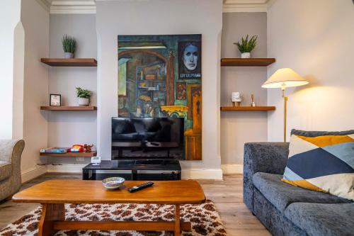 a living room with a couch and a coffee table at Motorpoint Arena House - Sleeps 10 in Nottingham