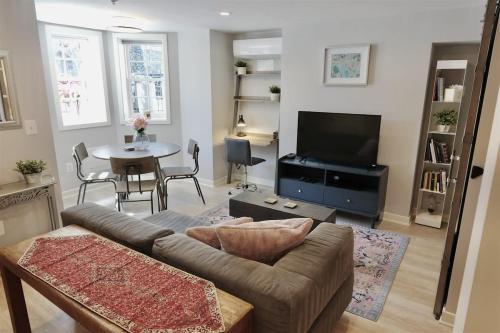 a living room with a couch and a table at Downtown DC Awaits with Parking Permit in Washington, D.C.